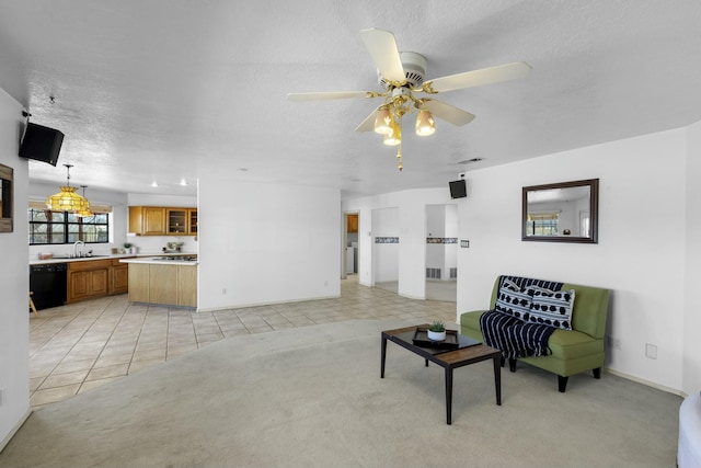 carpeted living room with sink, a textured ceiling, and ceiling fan