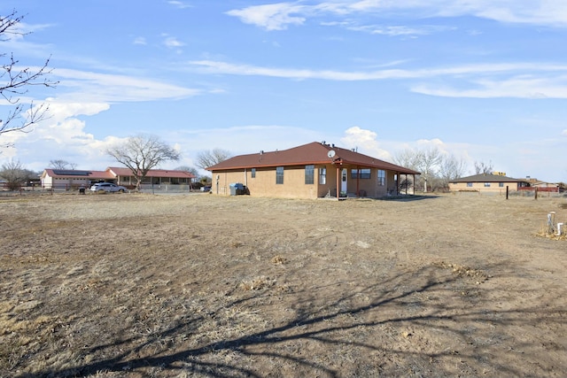 1 Blackberry Ln, Los Lunas, NM 87031 - rear view of property with fence and stucco siding