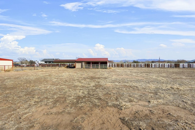 view of yard featuring an outbuilding and a rural view