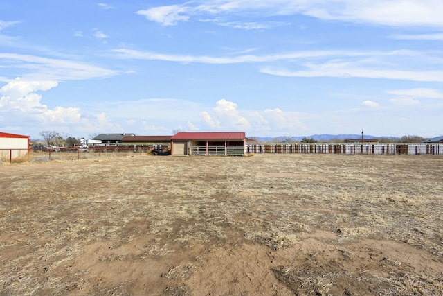 1 Blackberry Ln, Los Lunas, NM 87031 - back of property featuring an outdoor structure, an enclosed area, an outbuilding, fence, and an exterior structure