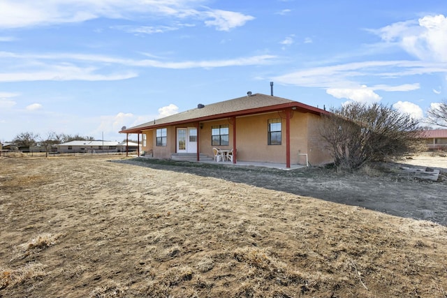 back of property with a patio