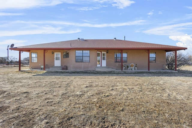 1 Blackberry Ln, Los Lunas, NM 87031 - rear view of house featuring stucco siding and a shingled roof