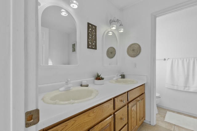 bathroom featuring vanity, tile patterned floors, and toilet