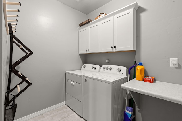 washroom featuring cabinets, separate washer and dryer, and light tile patterned floors