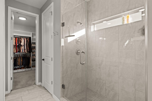 bathroom with tile patterned flooring and a shower with door