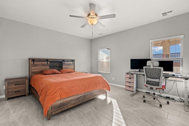 bedroom with multiple windows and ceiling fan