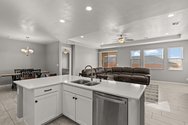 kitchen featuring white cabinetry, dishwasher, sink, and an island with sink