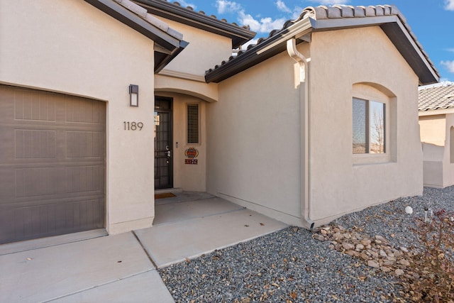 doorway to property featuring a garage