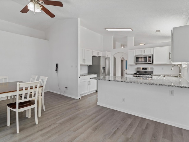 kitchen featuring white cabinetry, sink, light stone counters, and stainless steel appliances