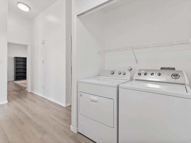 washroom with washer and dryer and light wood-type flooring