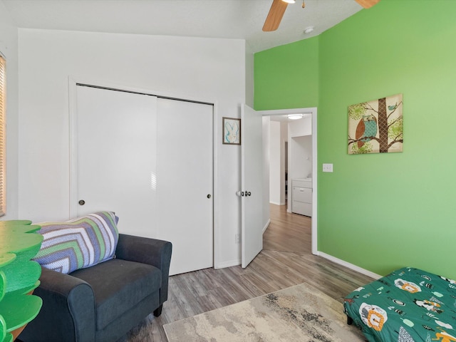 sitting room with hardwood / wood-style flooring, ceiling fan, and vaulted ceiling