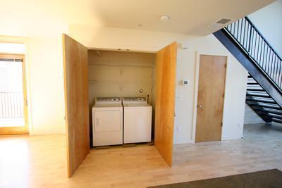 laundry area with light hardwood / wood-style floors and washing machine and dryer