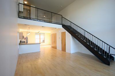 stairway featuring a towering ceiling and hardwood / wood-style floors