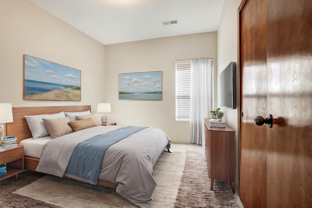 bedroom featuring light carpet