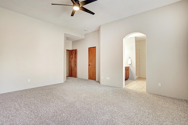 unfurnished room featuring light colored carpet and ceiling fan