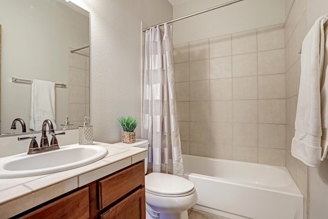 full bathroom featuring shower / bath combo, vanity, and toilet