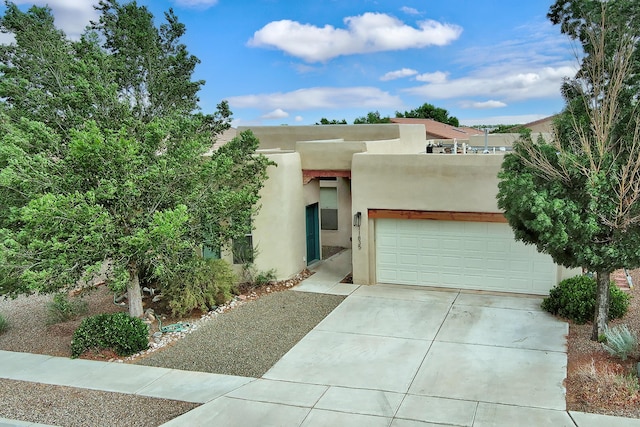 pueblo-style house with a garage