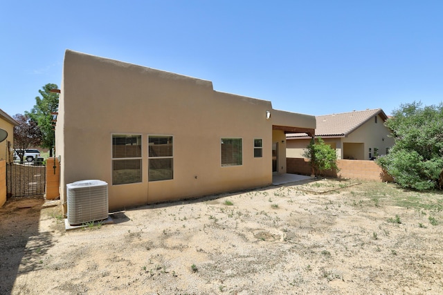 rear view of property featuring central air condition unit