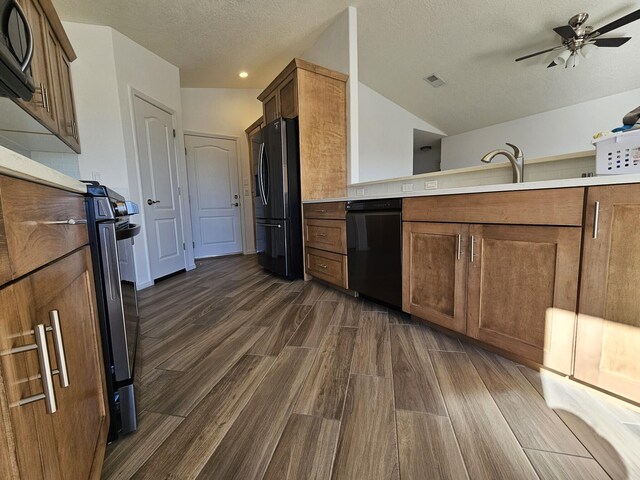 kitchen with lofted ceiling, sink, ceiling fan, black appliances, and a textured ceiling