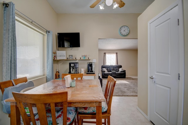 carpeted dining space featuring ceiling fan