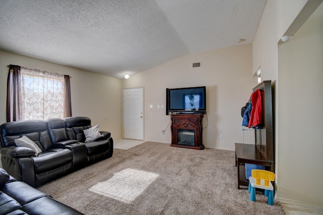 carpeted living room featuring vaulted ceiling and a textured ceiling