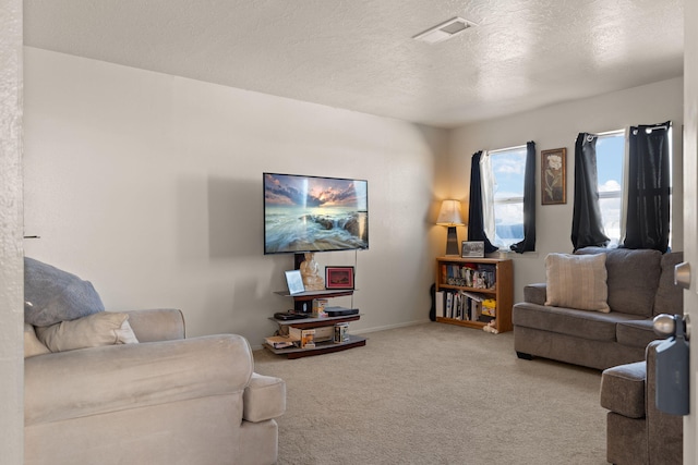 living room featuring carpet flooring and a textured ceiling