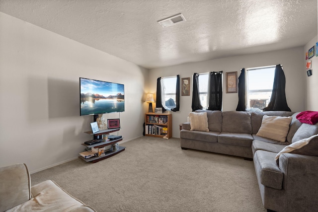 living room with light colored carpet, plenty of natural light, and a textured ceiling