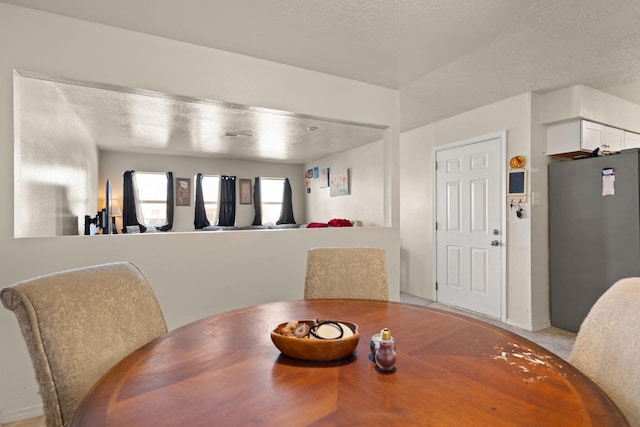 dining area with a textured ceiling