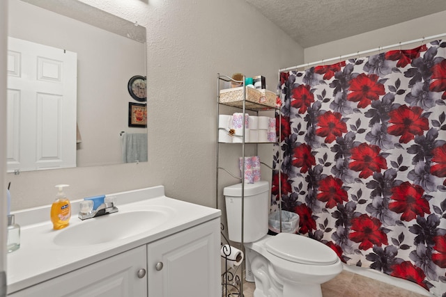 bathroom with vanity, walk in shower, a textured ceiling, and toilet