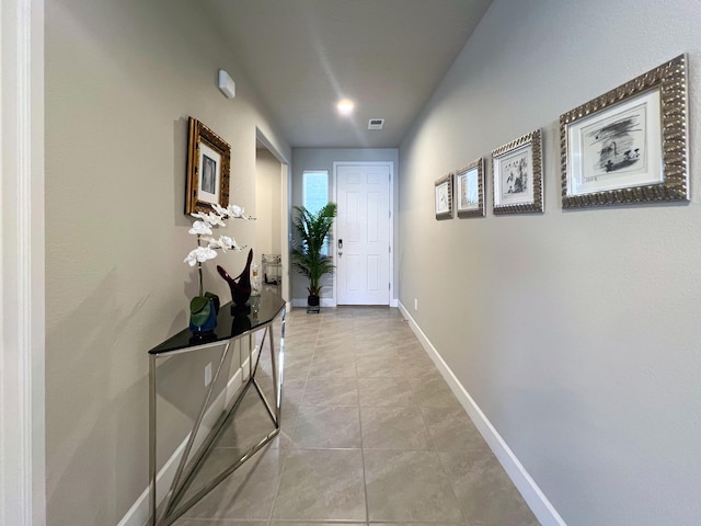 hall featuring light tile patterned floors