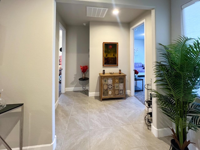 corridor featuring light tile patterned floors