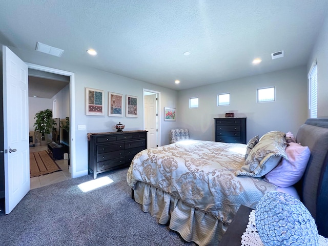 carpeted bedroom featuring a textured ceiling