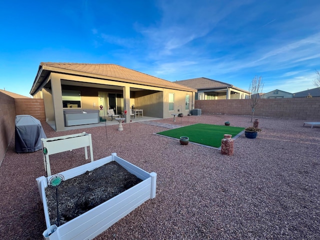 back of property with central AC and a patio area