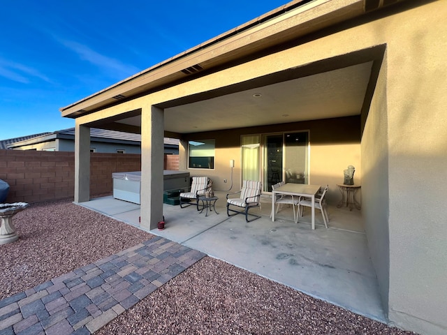 view of patio / terrace with a hot tub