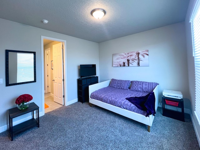 bedroom with carpet floors and a textured ceiling