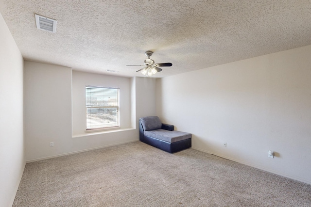 unfurnished room with ceiling fan, visible vents, and light colored carpet