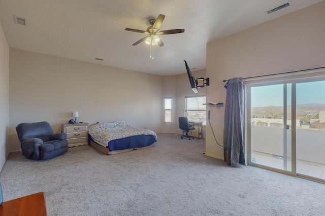 carpeted bedroom featuring access to outside, visible vents, and a ceiling fan