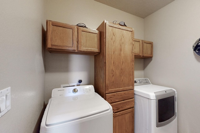 laundry area featuring cabinet space and a textured ceiling