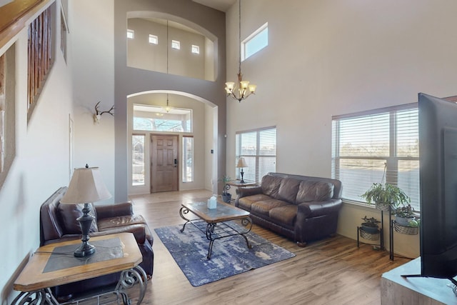 living room with an inviting chandelier and wood finished floors