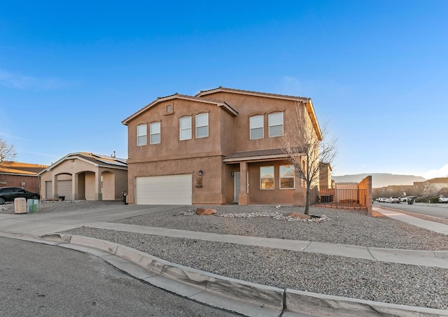 view of front of house with a garage and a mountain view