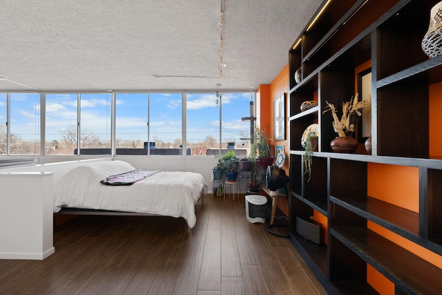 bedroom featuring dark hardwood / wood-style floors and a textured ceiling