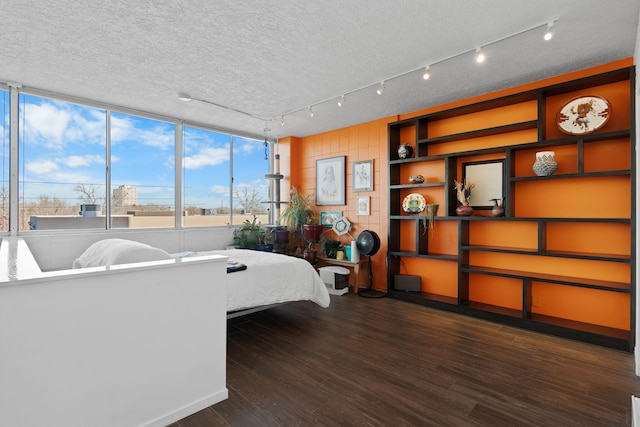 bedroom with dark hardwood / wood-style flooring and a textured ceiling