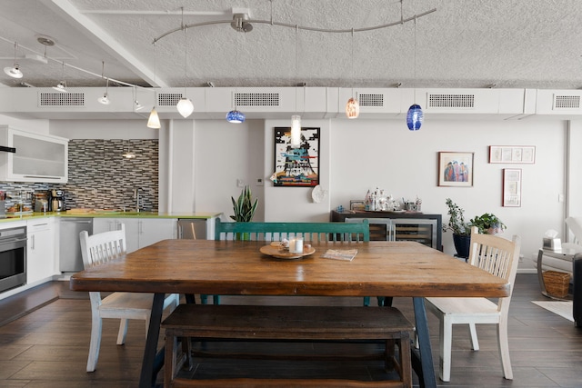 dining area featuring sink and dark hardwood / wood-style floors