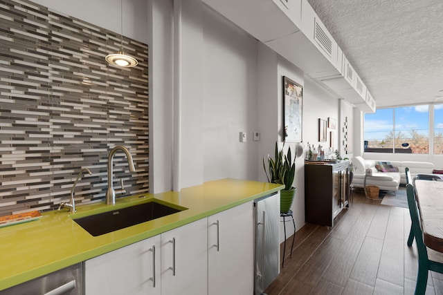 kitchen featuring dishwasher, white cabinetry, and sink