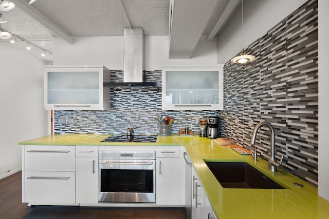 kitchen with wall chimney exhaust hood, sink, black cooktop, oven, and white cabinets