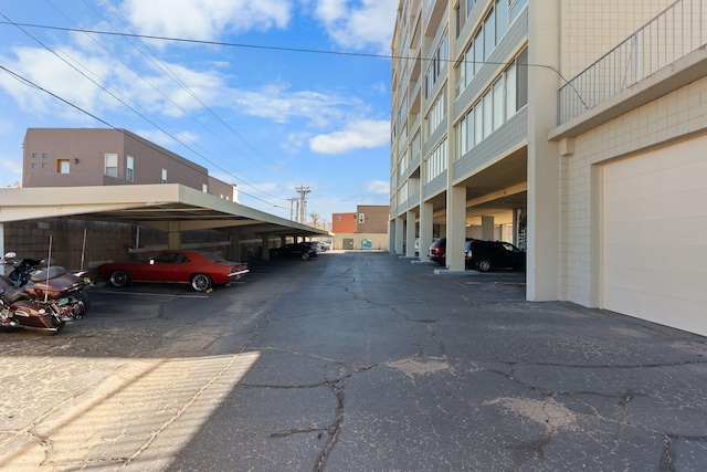 view of parking / parking lot featuring a carport