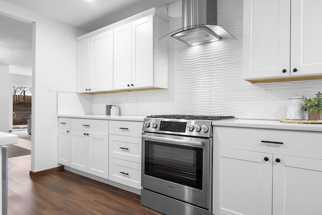 kitchen featuring extractor fan, stainless steel gas stove, dark hardwood / wood-style flooring, decorative backsplash, and white cabinets