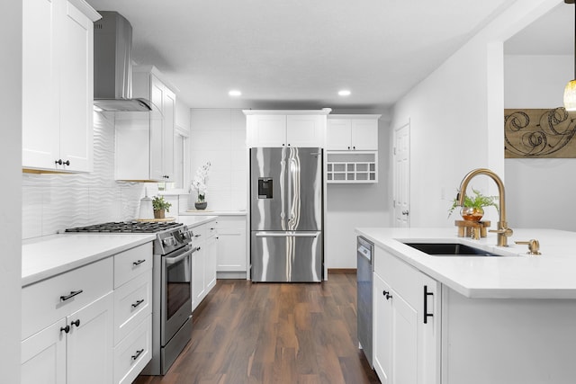 kitchen featuring white cabinetry, appliances with stainless steel finishes, sink, and wall chimney range hood