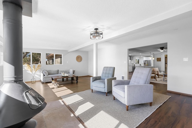 living room featuring a wood stove and dark hardwood / wood-style floors