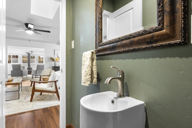 bathroom featuring sink, hardwood / wood-style flooring, and ceiling fan